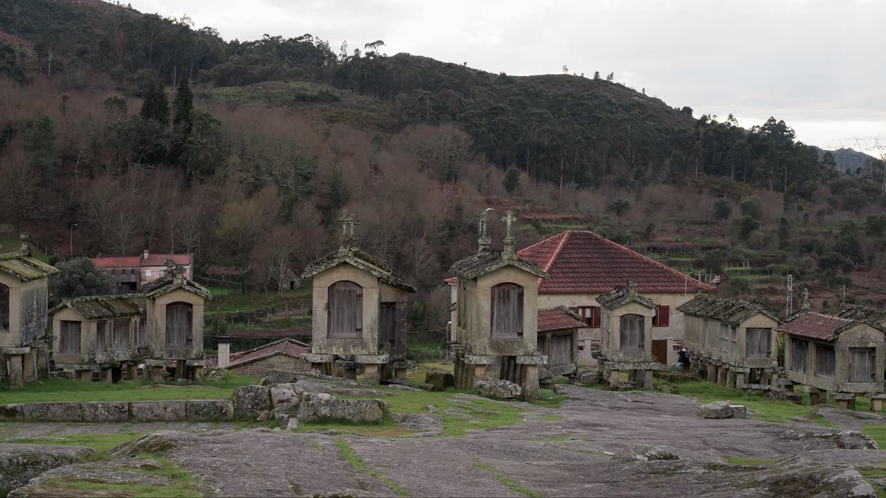 Traditional stone granaries of Lindoso in Alto Minho Portugal with forest backdrop