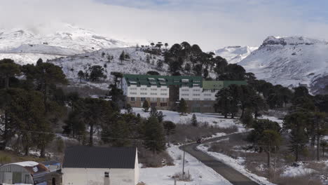 Drone view of Luxury Caviahue Ski Resort in Patagonia Argentina surrounded by snowy Andes mountain peaks
