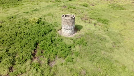 Drone-view-in-front-of-the-lime-kiln-at-Pointe-au-Sel-in-Saint-Leu,-Reunion-Island,-with-ascending-and-tilt-down-movement