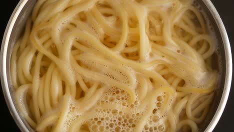 spaghetti cooking in a pot