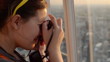 tourist taking photograph of sunset in london skyline  view from the shard