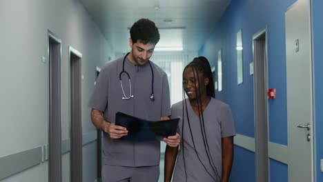 doctors reviewing x-ray in a hospital corridor