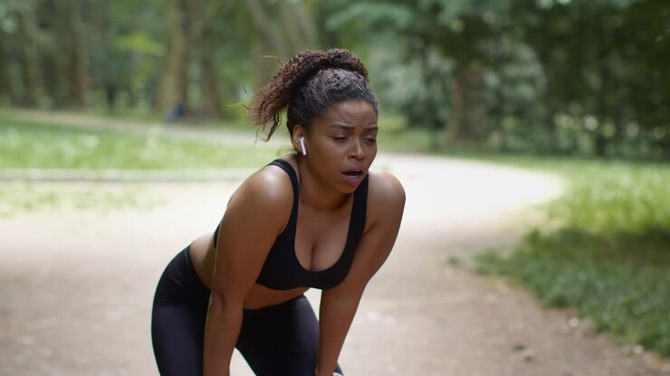 Woman taking a break after jogging in a park