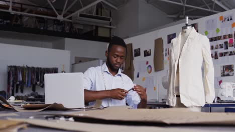 Mixed-race-man-working-in-fashion-office