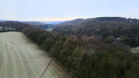 an aerial drone shot flying over a winter reservoir scene