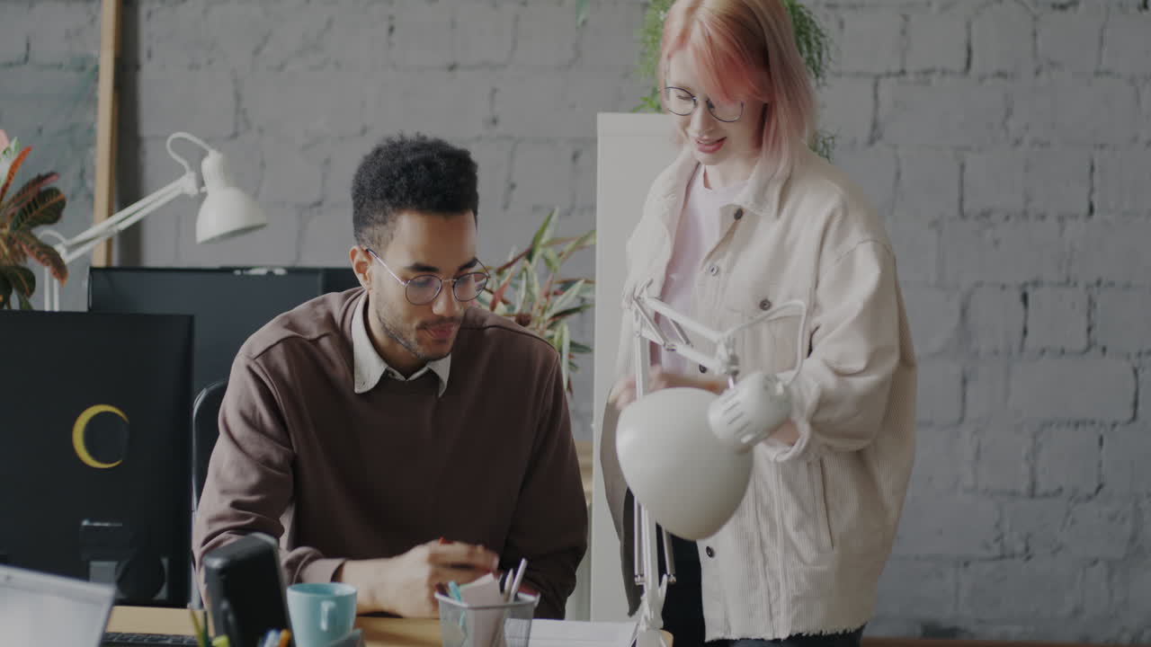 Two colleagues working together in a modern office