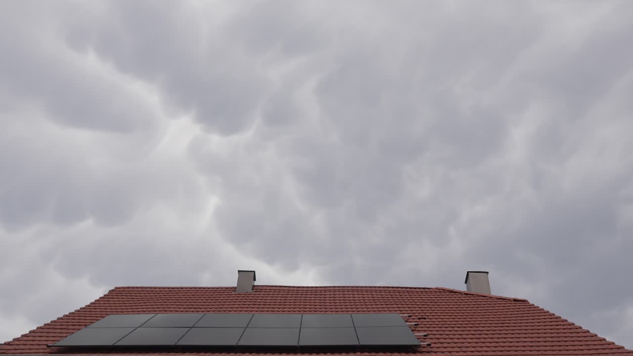 Modern house roof with solar panels green energy Nimbostratus clouds passing time-lapse