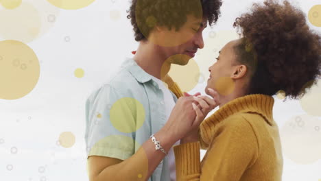 Animación-De-Puntos-De-Luz-Sobre-Una-Feliz-Pareja-Birracial-Bailando-En-La-Playa.