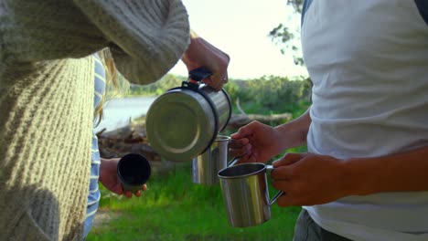 Mittelteil-Einer-Frau,-Die-Wasser-In-Eine-Kaffeetasse-Gießt-4k