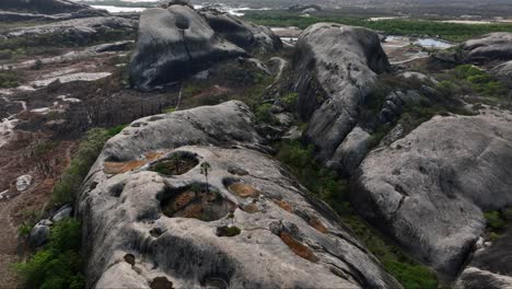 aerial view of granite rock formation with eroded panholes in brazil