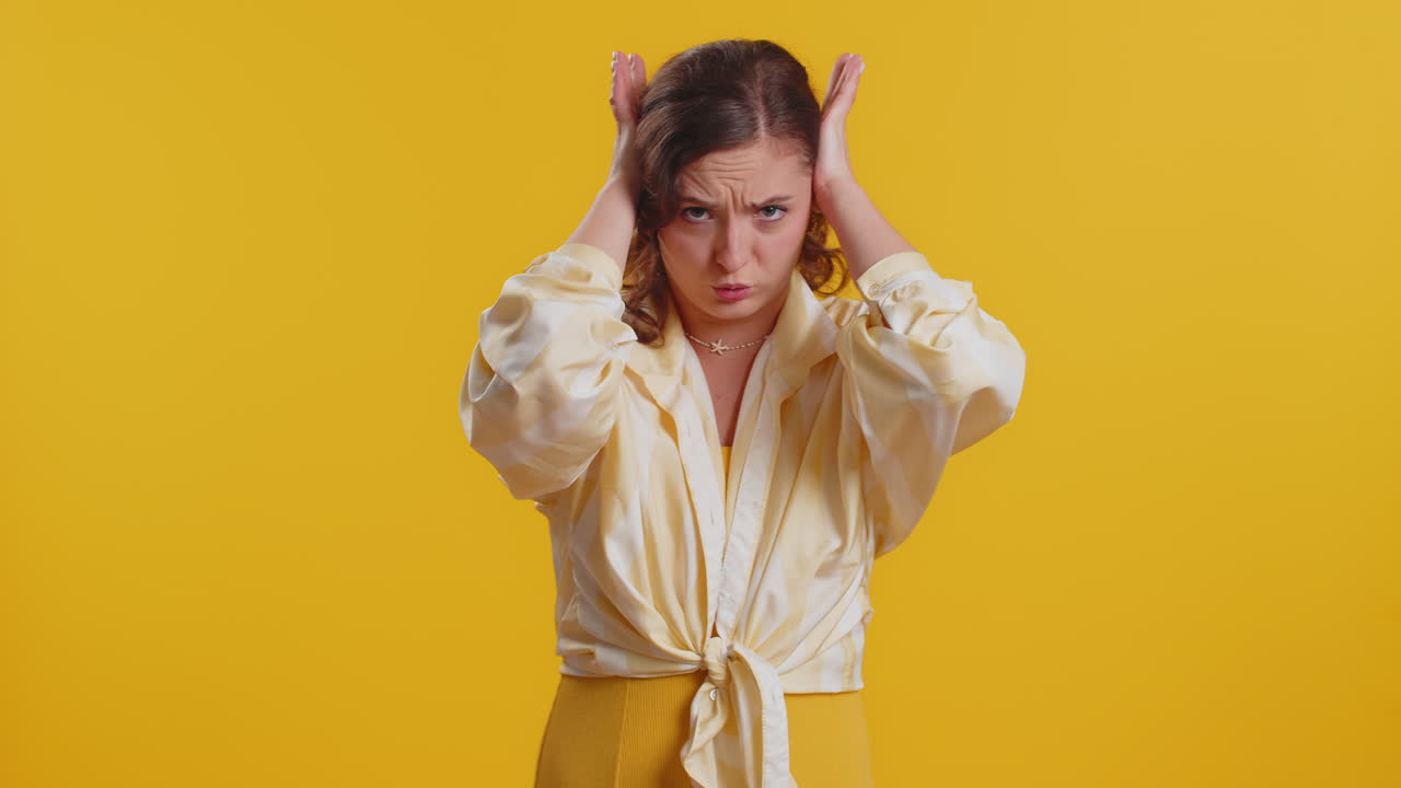 Annoyed irritated young woman covering ears gesturing no avoiding advice ignoring noise loud voices