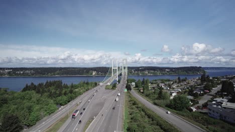 A-beautiful-cloudy-day-along-Puget-Sound-and-the-Tacoma-Narrows-Bridge,-aerial-pan