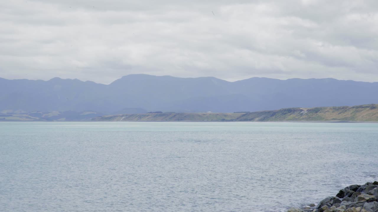 Serene Coastal Landscape with Distant Mountains