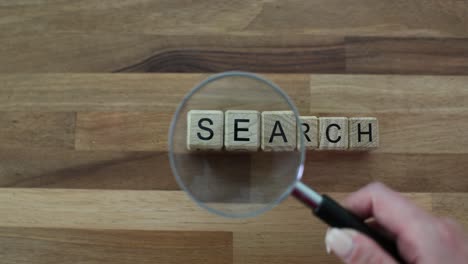 magnifying glass over 'search' text blocks