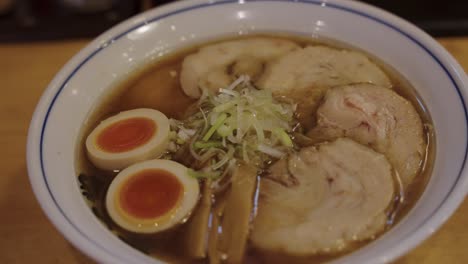 close pan over japanese ramen with pork, eggs and vegetables