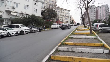 city street with parked cars and stairs