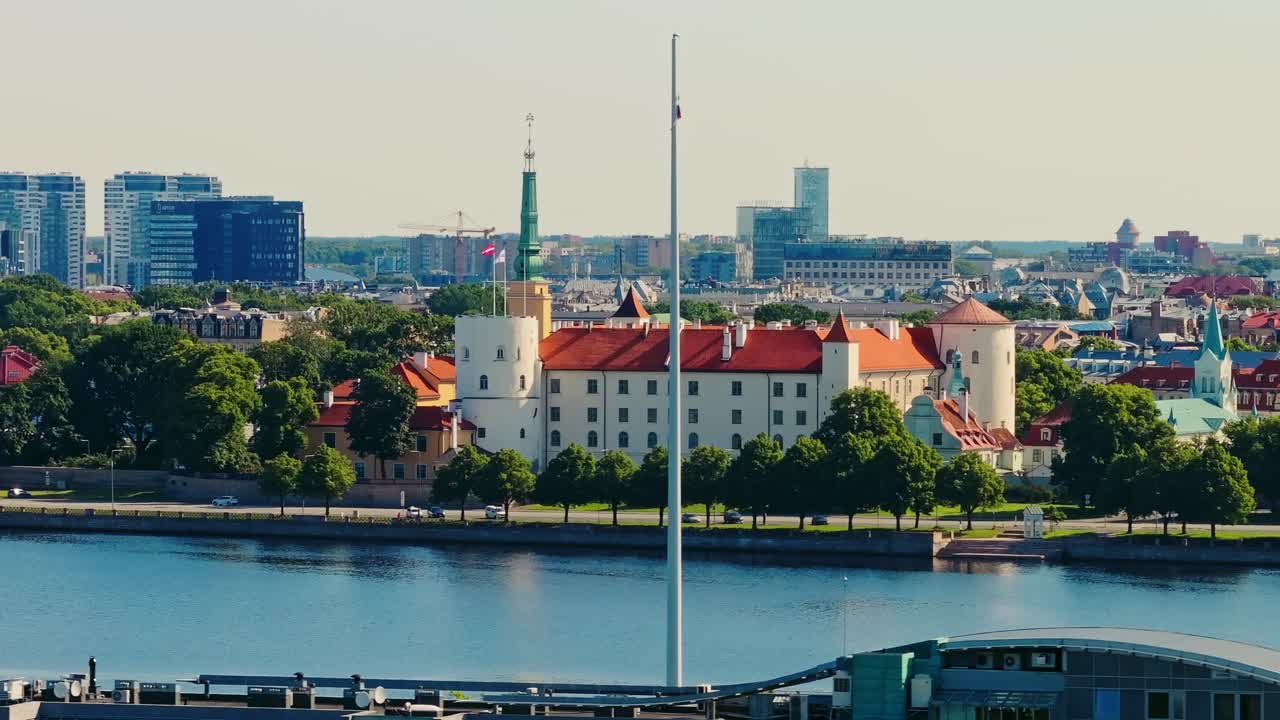 Cinematic drone shot shows Riga Castle with flagpole and no flag in summer light