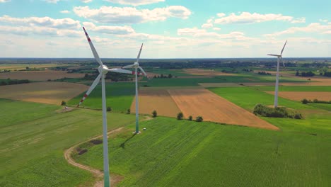 aerial view of powerful wind turbine farm for energy production on beautiful cloudy sky at highland