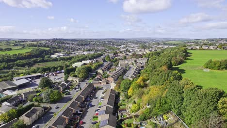 aerial drone footage a scenic view of houses and green trees at the residential terraced housing in the united kingdom - aerial shot