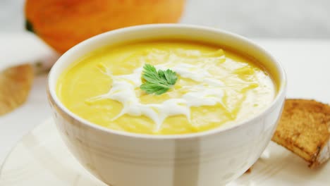 Pumpkin-soup-in-bowl-served-with-bread