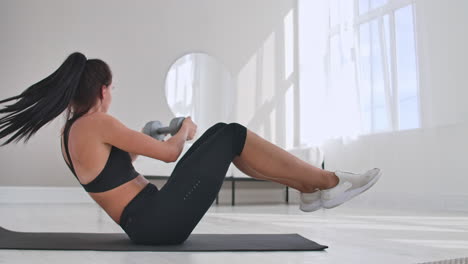 profile side view photo portrait of charming gorgeous sporty sportive concentrated beautiful with ponytail brunette lady doing crunches on purple carpet at the weekend leading healthy lifestyle