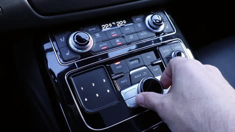 hand operating luxury car console close up