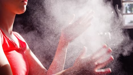 Woman-dusting-his-hands-with-chalk-powder