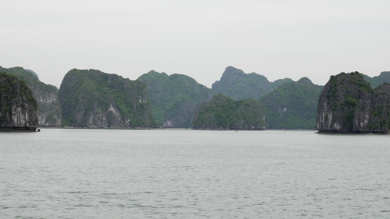Cruise view in Cat Ba Island, Vietnam, showing limestone karst formations rising from the sea