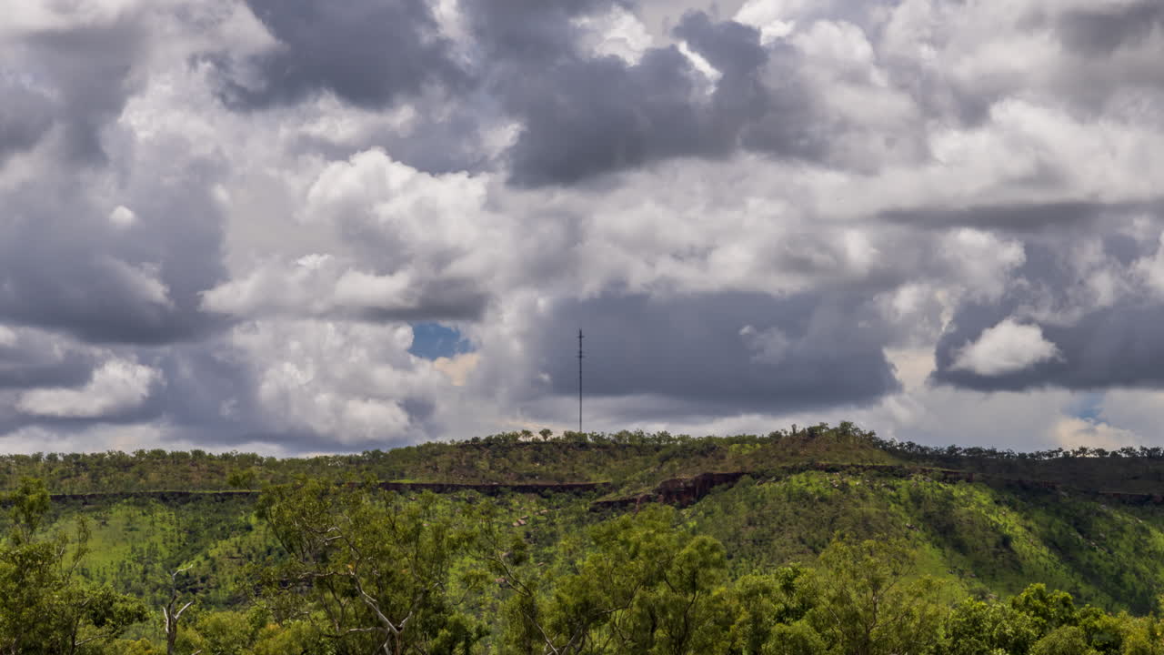 lapso de tiempo de nubes de tormenta sobre una montaña con una torre de telecomunicaciones en el territorio del norte