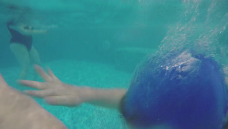 kid swimming breaststroke in the pool