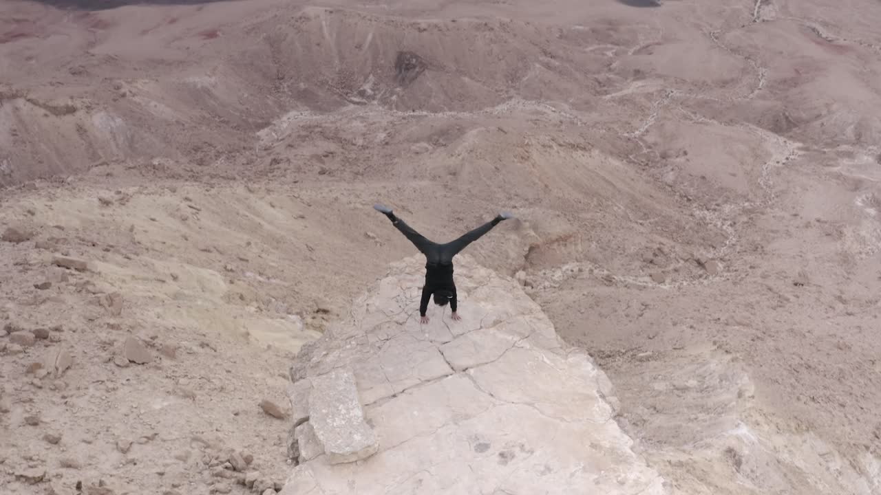 Man Performing Handstand in a Desert Landscape