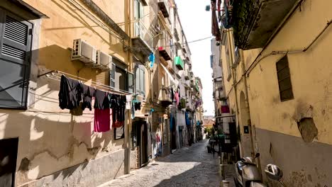 a narrow street with hanging laundry