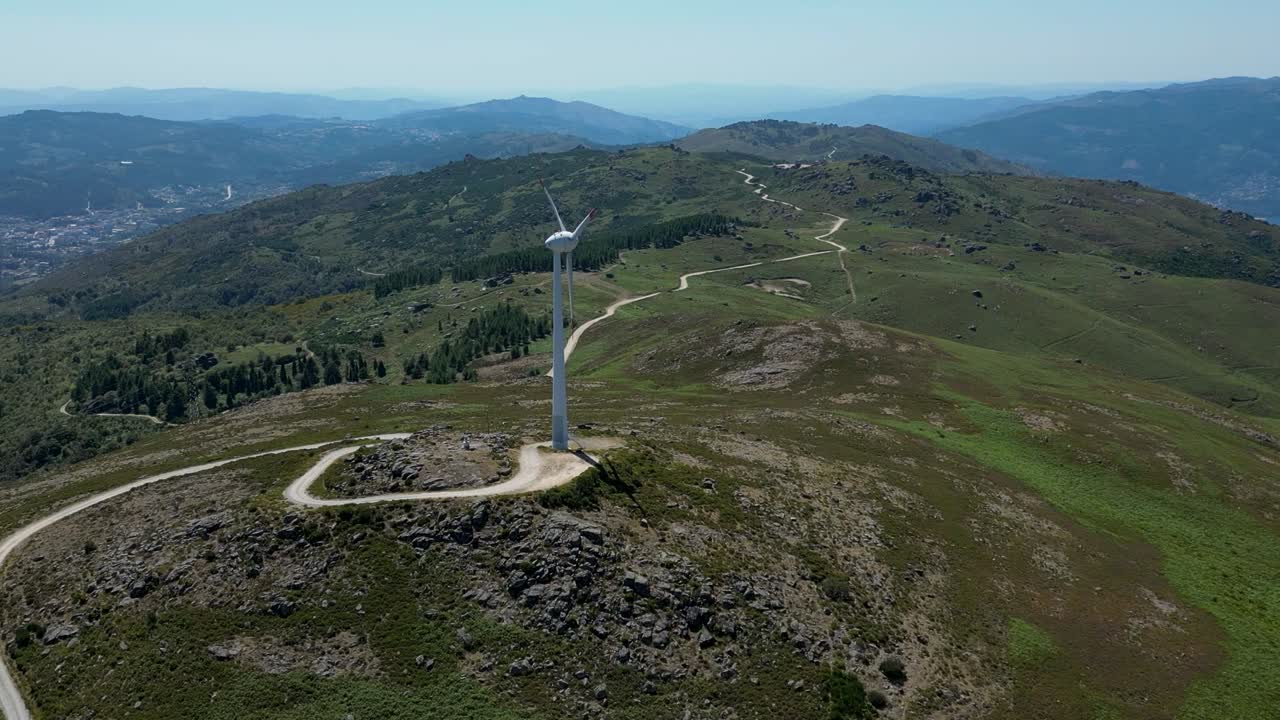 wind turbine rotating on top of a mountain overlooking Ger&ecirc;s, renewable wind energy portugal