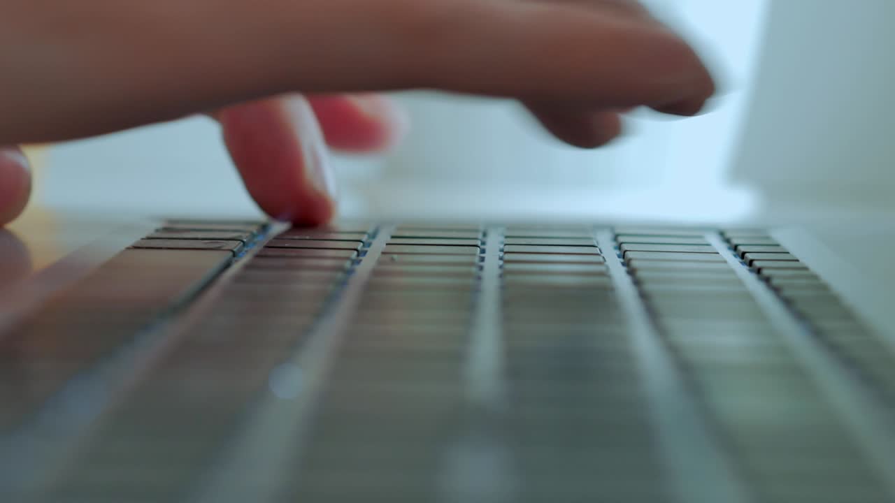 Men's fingers print text on the keyboard, close -up, selective focus, chamber movement