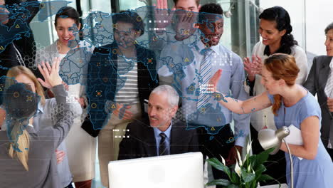 animation of world map with icons over happy diverse female and male coworkers in office