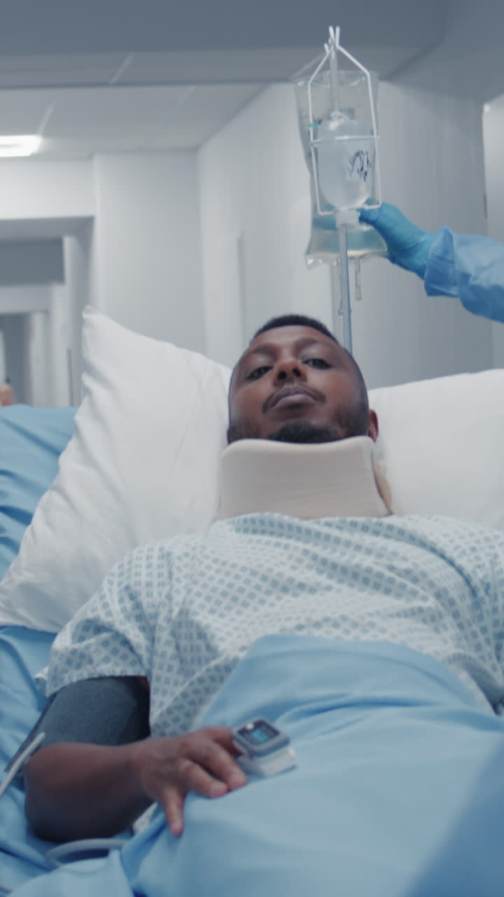 Man with neck brace lies on stretcher in clinic 4k 2025 08 05 00 31 12 utc.mov | african american, assistance, care, caucasian