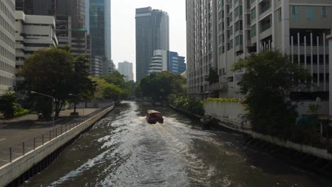 bangkok city, a bustling urban landscape with a boat traversing the waterway