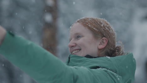 smiling girl taking a selfie in the snow