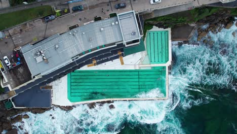 drone top shot over bondi beach iceberg swimming pool in sydney australia