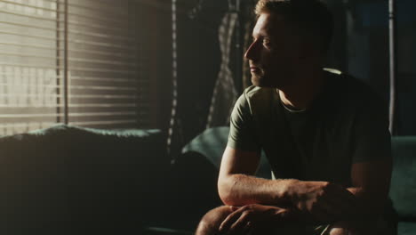 man sitting on a sofa contemplating