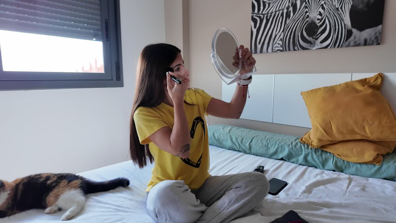 Woman applying makeup in bedroom