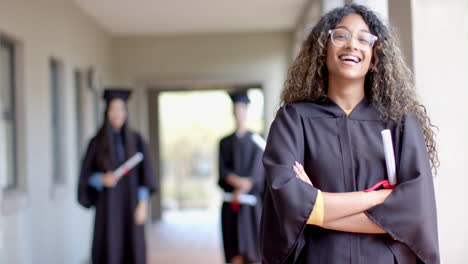 proud graduate stands in high school hallway, with copy space