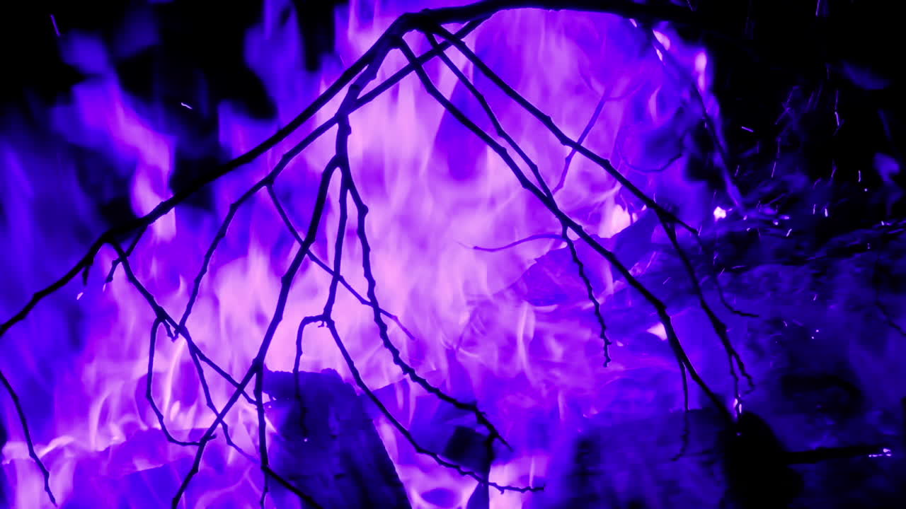 Deliberate blurring and color manipulation : a blazing campfire's fiery flames dancing in the darkness