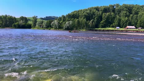 serene river landscape: capturing the tranquility and beauty of nature with lush green hills and vibrant water in a peaceful outdoor setting