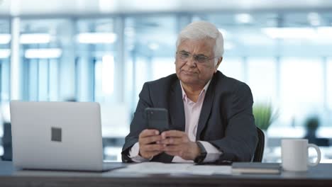 Indian-senior-manager-using-mobile-phone