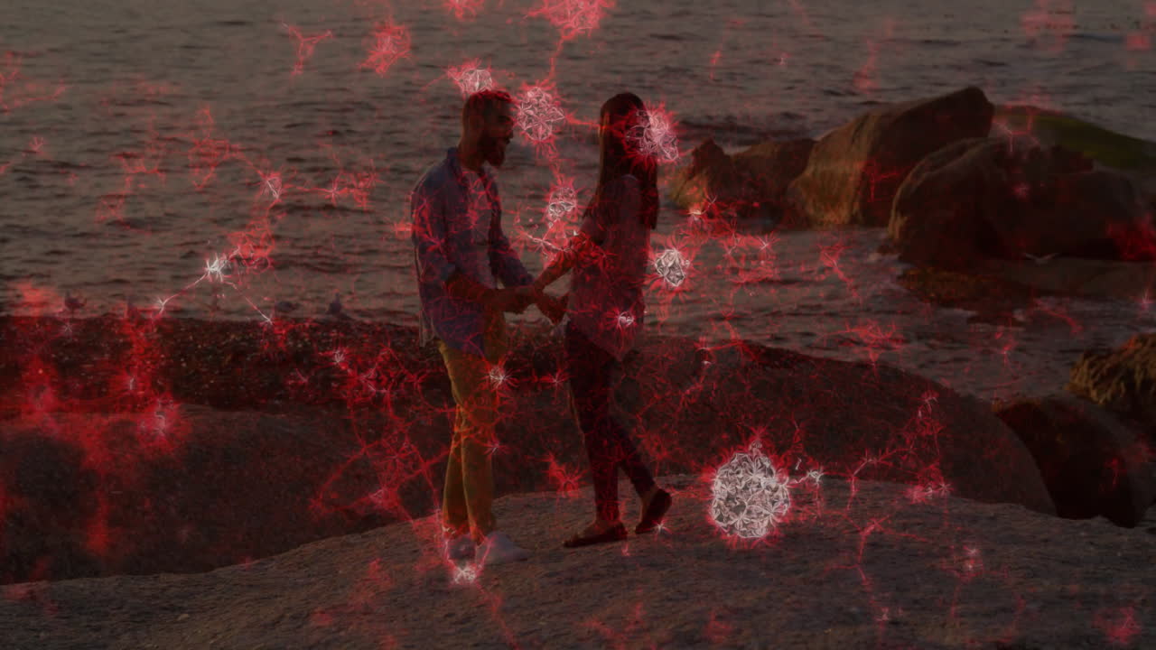 Couple holding hands on beach with red neural network animation overlay