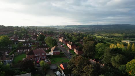 yorkshire's residential district: aerial drone view of the uk's red brick council estate, bathed in the morning sun, with homes and residents on the streets