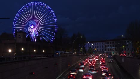 the ferris wheel illuminated during the christmas period at the amusement park at the fortezza da basso. italy.