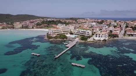 aerial view of a coastal resort town with turquoise waters and beach