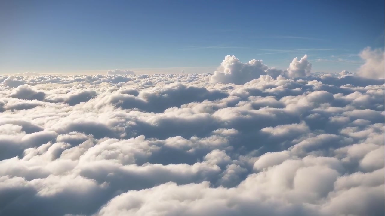 Aerial View of Fluffy White Clouds and Blue Sky